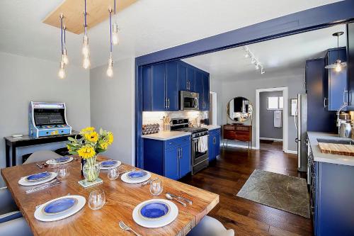 a kitchen with blue cabinets and a wooden table at Bed and Biscuit in Guerneville
