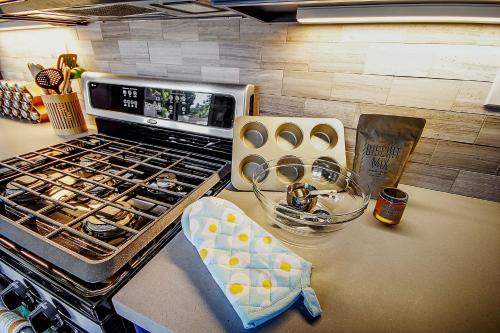a kitchen counter with a stove top with a bunch of food at Bed and Biscuit in Guerneville