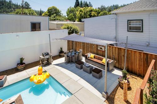 a backyard with a swimming pool and a house at Bed and Biscuit in Guerneville