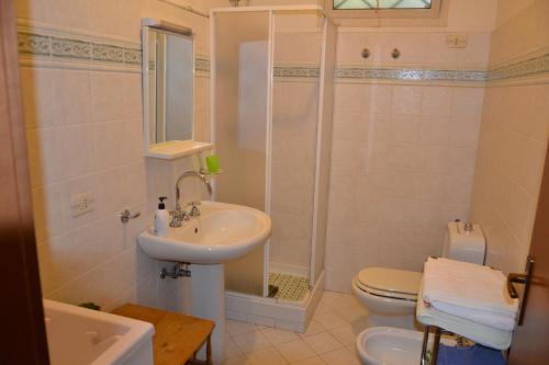 a bathroom with a sink and a toilet and a shower at Low Cost La Meridiana in Zafferana Etnea