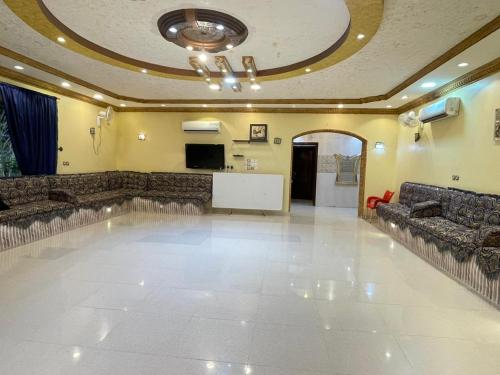 a dance floor in a room with couches at شالية الفوز in Al Madinah