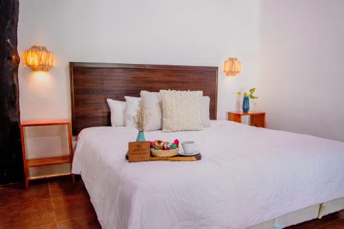 Ein Bett oder Betten in einem Zimmer der Unterkunft Las Nubes de Holbox