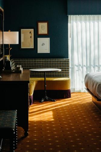 a bedroom with a bed and a desk and a table at The Hotel Chalet at The Choo Choo in Chattanooga