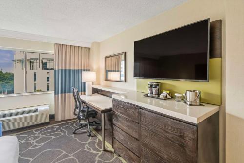 a hotel room with a desk and a television at Doubletree by Hilton Charlotte Uptown in Charlotte