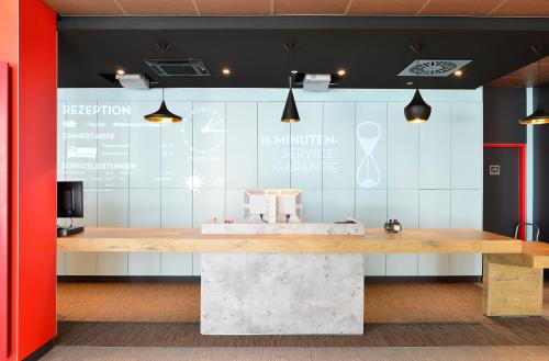 a large counter in a room with a table at Ibis Muenchen City Ost in Munich