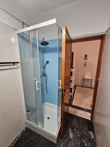 a shower with a glass door in a bathroom at VILLAGE SINTRA gh in Sintra
