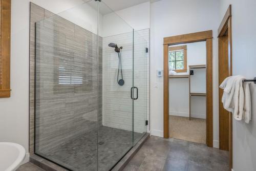 a glass shower stall in a bathroom with a toilet at Suncadia 4 Bdrm Home with Hot Tub Overlooking Golf Course in Cle Elum