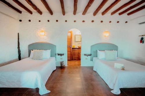 Ein Bett oder Betten in einem Zimmer der Unterkunft Las Nubes de Holbox