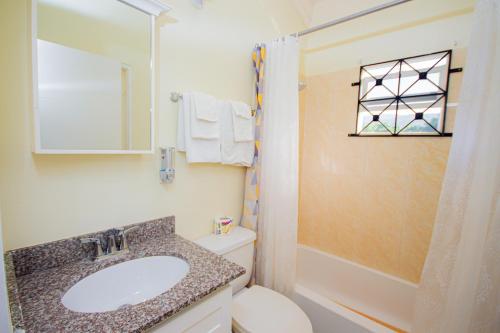 a bathroom with a sink and a toilet and a shower at Ocho Rios Drax Hall Manor 3 Bed Getaway in Mammee Bay