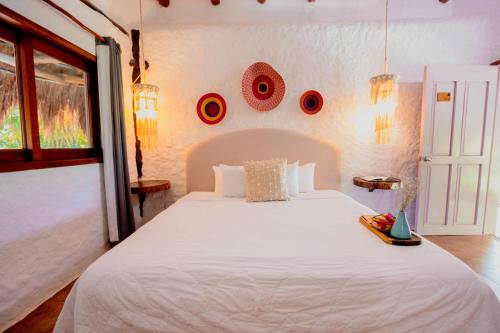 Ein Bett oder Betten in einem Zimmer der Unterkunft Las Nubes de Holbox