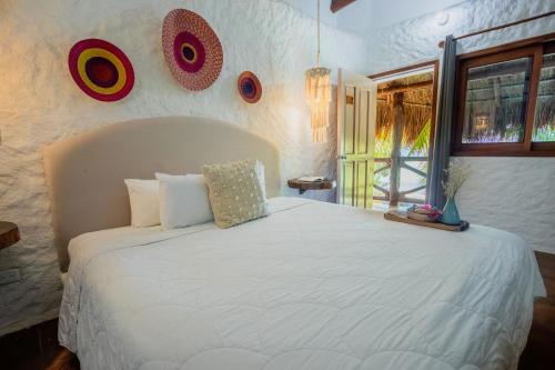 Ein Bett oder Betten in einem Zimmer der Unterkunft Las Nubes de Holbox