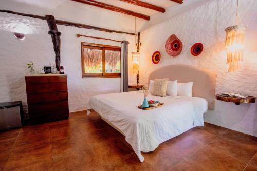 Ein Bett oder Betten in einem Zimmer der Unterkunft Las Nubes de Holbox