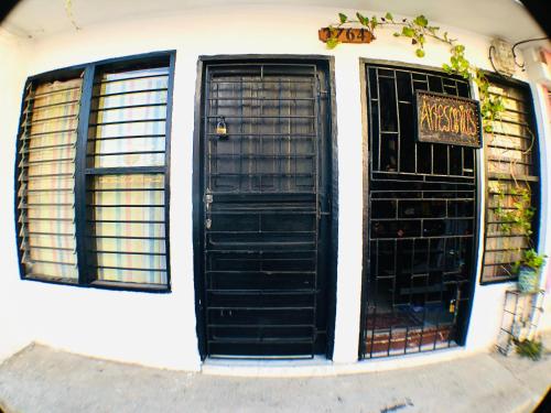 two black doors on the side of a building at AptoPuntoCentro Santa Marta in Santa Marta
