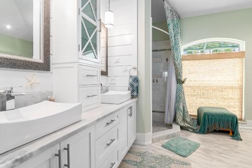 a white bathroom with a sink and a shower at Perfect Blend of Elegance and Comfort I Captivating Home For Idyllic Retreat in Marco Island