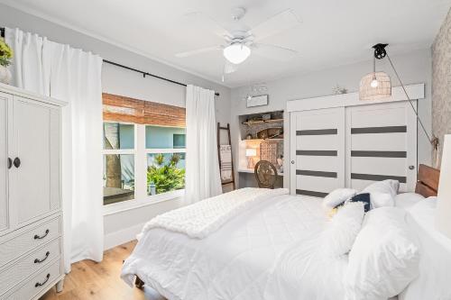 a white bedroom with a large bed and a window at Perfect Blend of Elegance and Comfort I Captivating Home For Idyllic Retreat in Marco Island