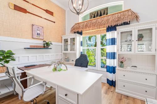 a kitchen with a white island and a window at Perfect Blend of Elegance and Comfort I Captivating Home For Idyllic Retreat in Marco Island