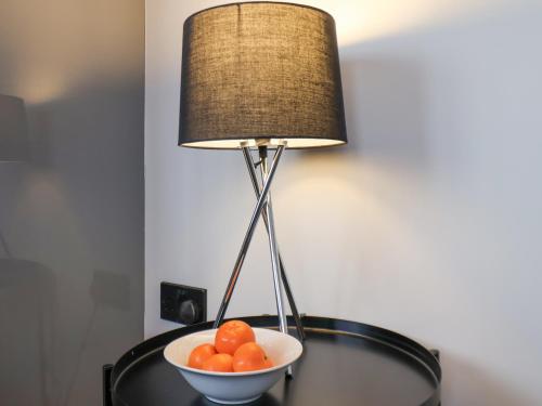 a bowl of oranges on a table next to a lamp at Apt 9 Hunter's Quay in Bridlington