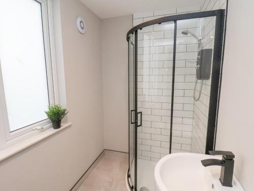 a bathroom with a shower and a sink at Apt 9 Hunter's Quay in Bridlington