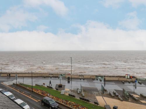 a view of the ocean with cars parked on a street at Apt 9 Hunter's Quay in Bridlington