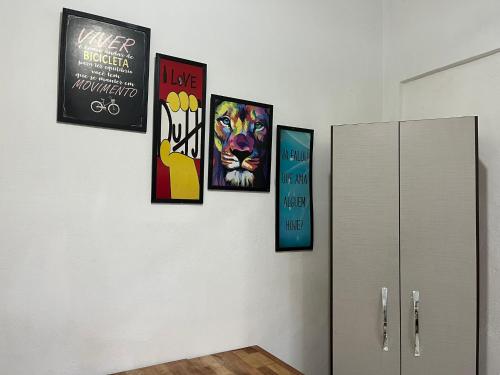 a group of four posters on a wall at Apartamento no Centro de Blumenau in Blumenau