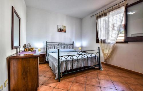 a bedroom with a bed and a table and a window at Casa Antonella in San Vito lo Capo