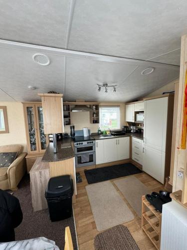a kitchen and living room in a house at 6 Berth Static Caravan, Golden Palm Resort, Chapel St Leonard's in Chapel Saint Leonards