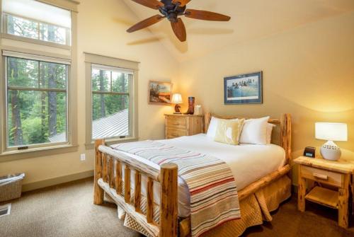 a bedroom with a large bed with a ceiling fan at Family Home, Hot Tub, Suncadia Pool Access in Cle Elum