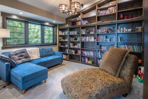 a living room with a couch and a chair and book shelves at Suncadia 5 Bdrm Home Perfect Private Retreat in Cle Elum