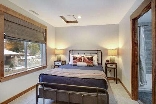 a bedroom with a bed and a large window at Great Location Near Pool with Suncadia Pool Access in Cle Elum