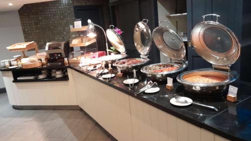 a buffet line with many plates of food at Orida Hotels Newbury in Newbury