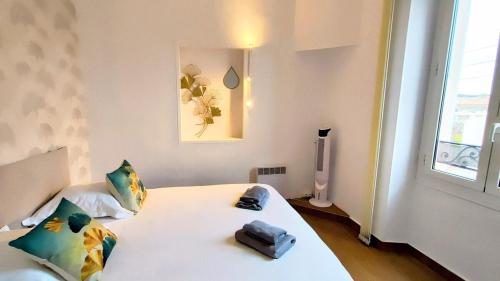 a bedroom with a bed with a phone on it at KOSY Spa, Les Princes in Cannes