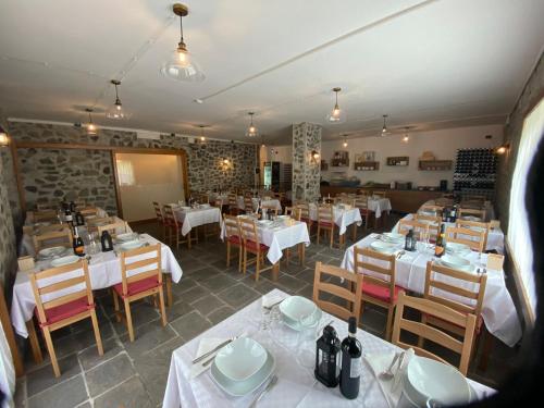 a restaurant with tables and chairs in a room at HOTEL ITALIA in Forni di Sopra