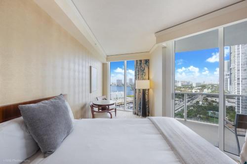 a bedroom with a bed and a large window at 15th Floor Luxury Suite at Trump Int Resort in Sunny Isles Beach