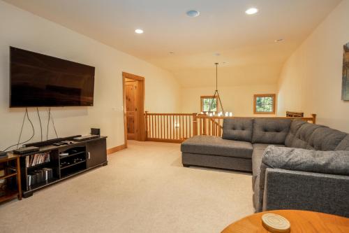 a living room with a couch and a flat screen tv at Suncadia 5 Bdrm Home Boasting 3,000 Square Feet of Fun for Families in Cle Elum