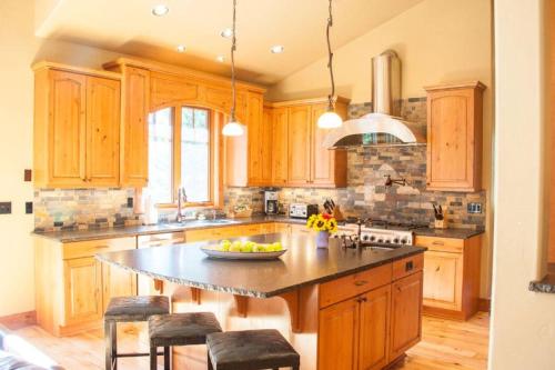 a kitchen with wooden cabinets and a large island at Suncadia 5 Bdrm Home that Sleeps 16 in Cle Elum