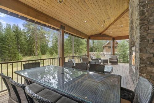 a patio with a table and chairs on a deck at Suncadia 5 Bdrm Home that Sleeps 16 in Cle Elum