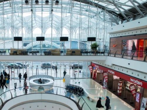 a large building with people walking in a shopping mall at Apartamento Lisboa Parque das Nações in Lisbon