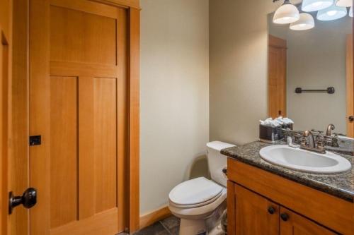 a bathroom with a white toilet and a sink at Suncadia 5 Bdrm Home with Hot Tub in Cle Elum