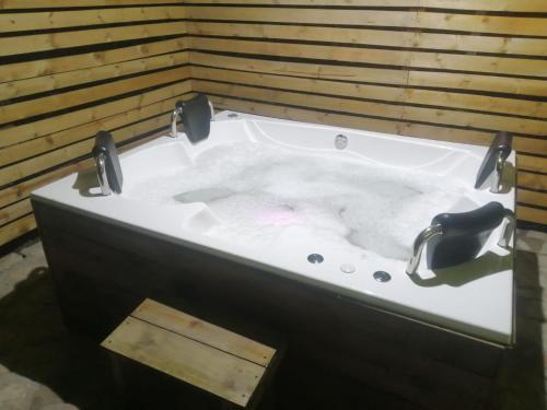 a bath tub with two faucets on top of it at Hotel Campestre Cabañas de la Sierra Nevada de El Cocuy in Panqueba