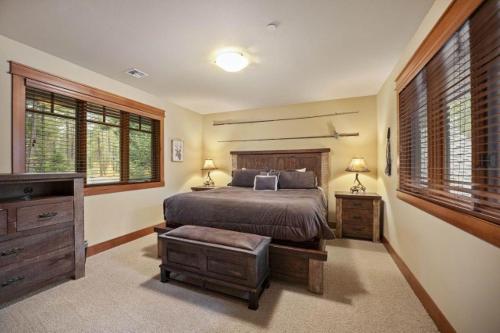 a bedroom with a bed and a dresser and windows at Suncadia 4 Bdrm Home with Private Hot Tub in Cle Elum