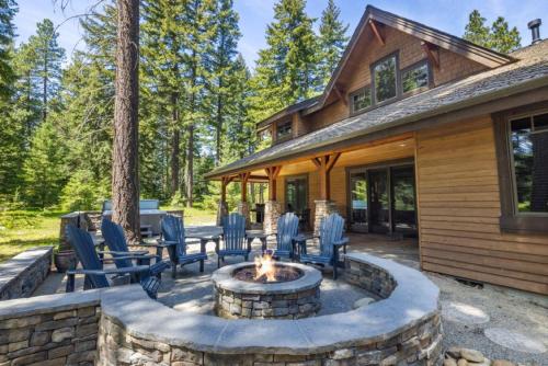 a patio with chairs and a fire pit in front of a house at Suncadia 4 Bdrm Home with Private Hot Tub in Cle Elum
