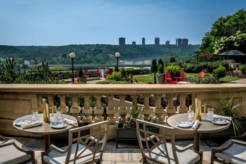 two tables on a balcony with a view at Fairmont Hotel Macdonald in Edmonton