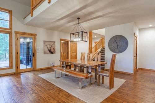 a dining room with a table and a clock on the wall at Suncadia 5 Bed Refined Alpine Home in Cle Elum