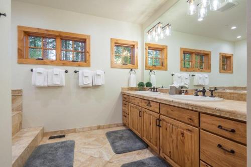 a bathroom with a double sink and a mirror at Suncadia 5 Bed Refined Alpine Home in Cle Elum
