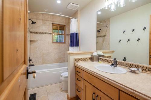 a bathroom with a sink and a tub and a toilet at Suncadia 5 Bed Refined Alpine Home in Cle Elum