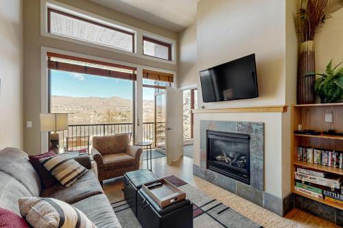 a living room with a fireplace and a tv at Chelan Resort Suites in Chelan