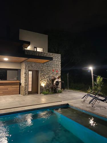 a swimming pool in front of a house at night at Loto San Lorenzo I Studio in San Lorenzo