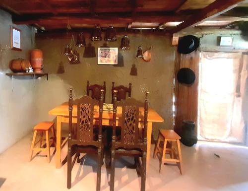 a dining room with a wooden table and chairs at ADOBE HOUSE in Cuenca