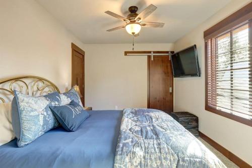 a bedroom with a blue bed with a ceiling fan at Suncadia 5 Bdrm Home Forested Hidden Gem in Cle Elum