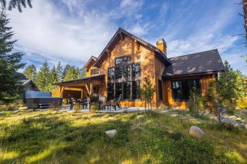 a log home with a patio and lawn at Suncadia 5 Bdrm Home Forested Hidden Gem in Cle Elum